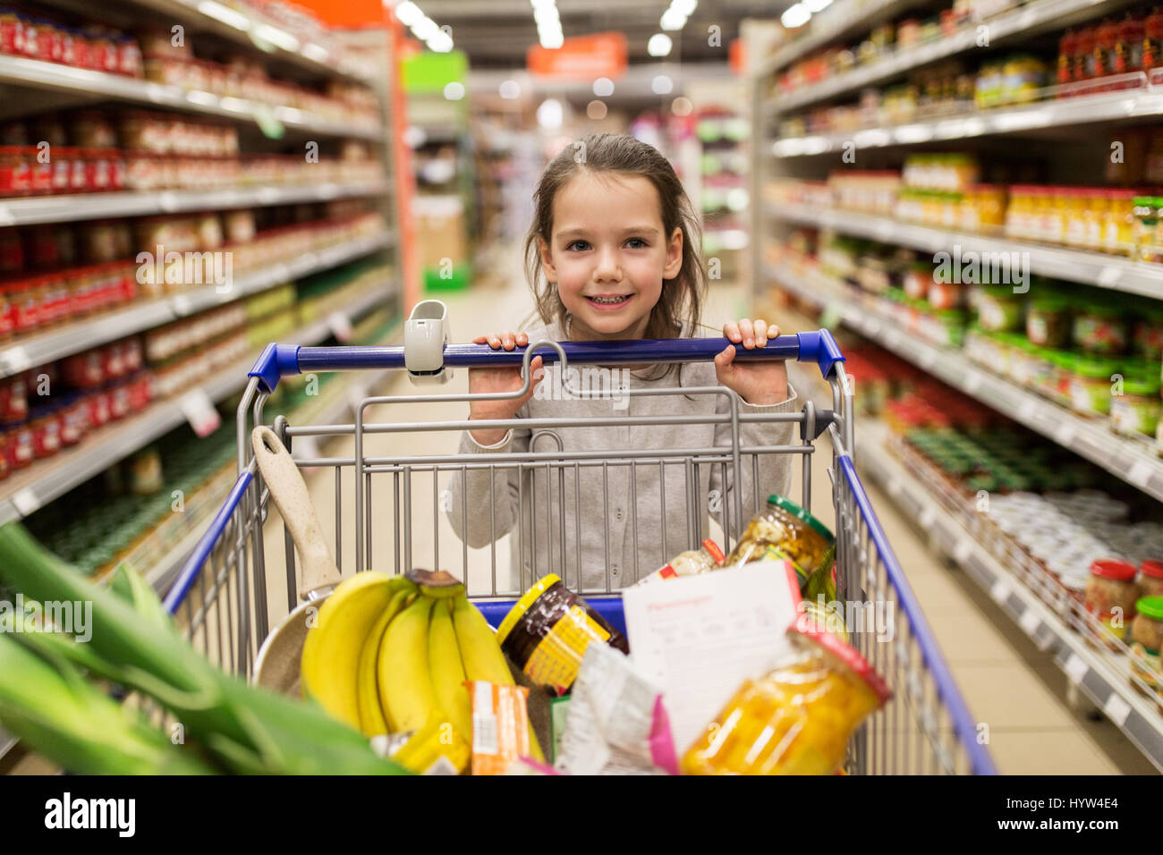 girl with food in shopping cart at grocery store Stock Photo Alamy