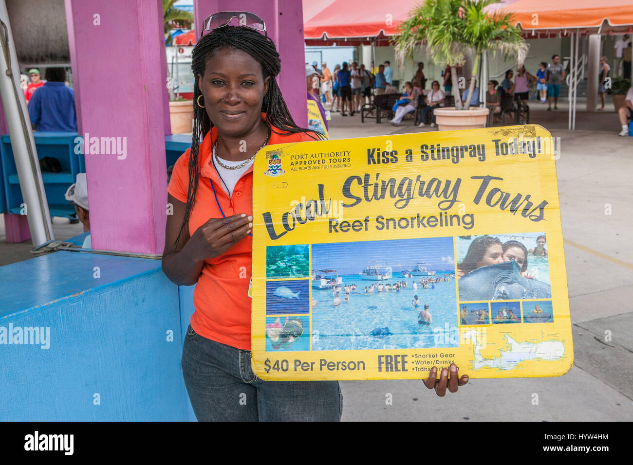 Young local woman selling tours of Sting Ray City Cayman Islands Stock Photo