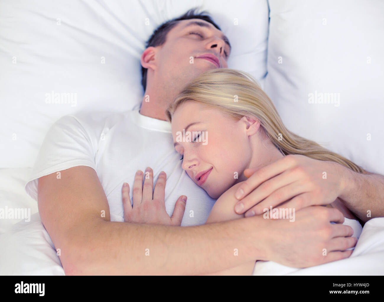 happy couple sleeping in bed Stock Photo - Alamy
