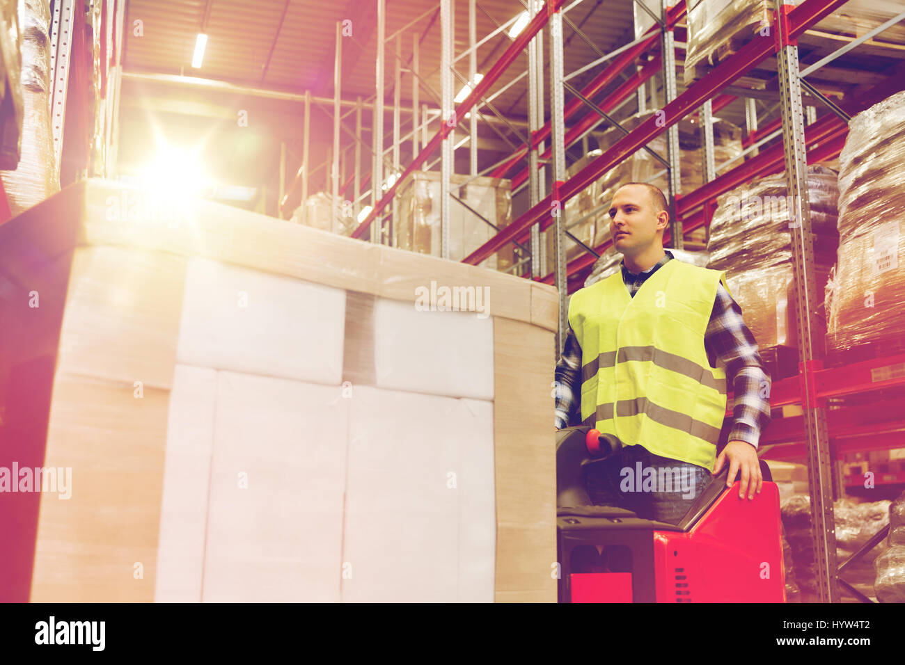 man with tablet pc operating forklift at warehouse Stock Photo
