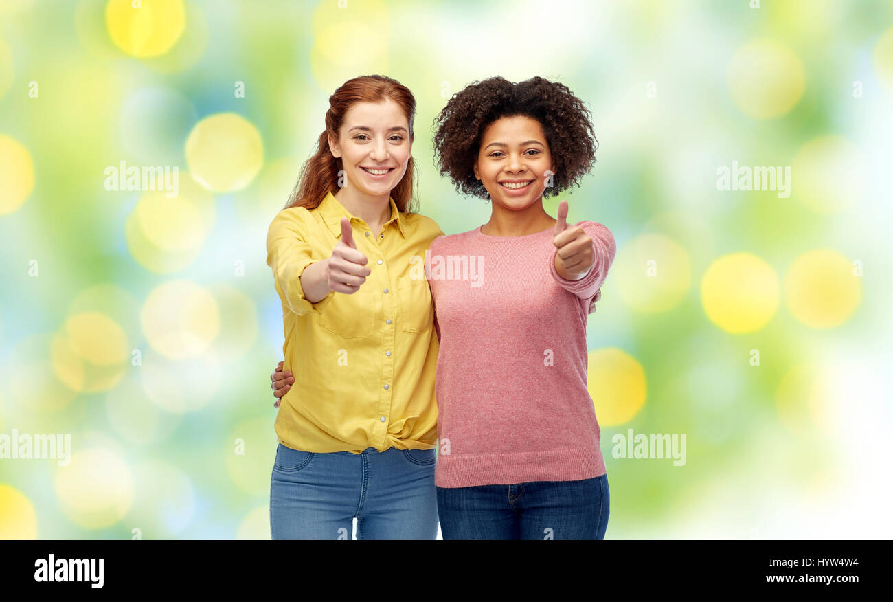 Two young women showing thumbs up hi-res stock photography and images ...