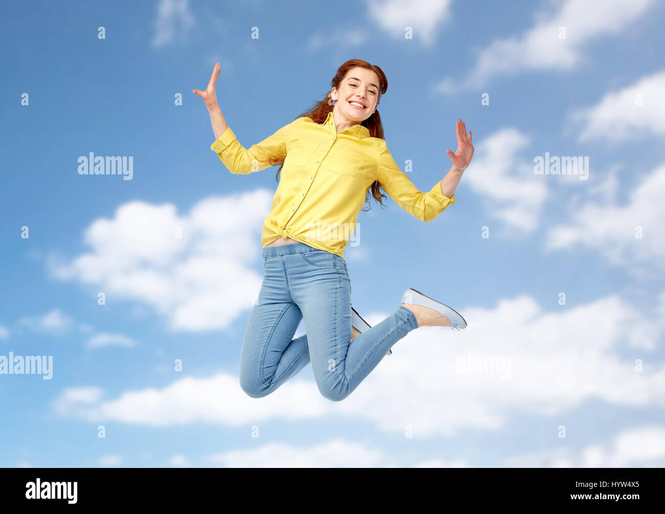 smiling young woman jumping in air Stock Photo - Alamy