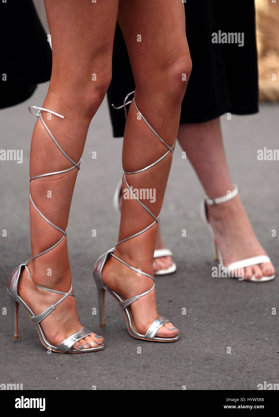 Female racegoers shoes on Ladies Day of the Randox Health Grand National Festival at Aintree Racecourse. Stock Photo