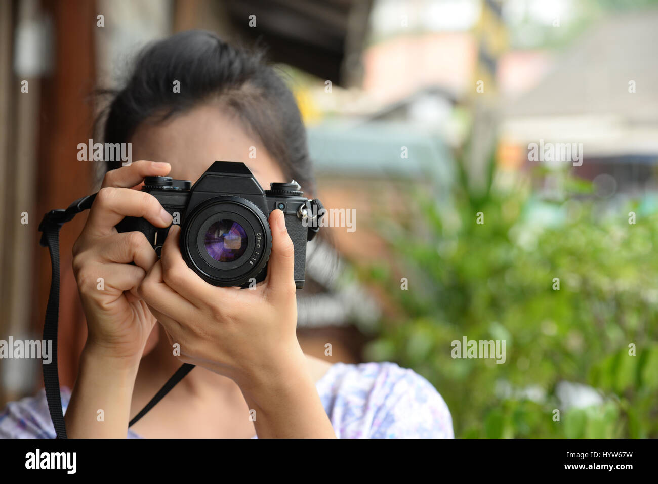 lady photographer in vintage dress holding retro film camera in her ...