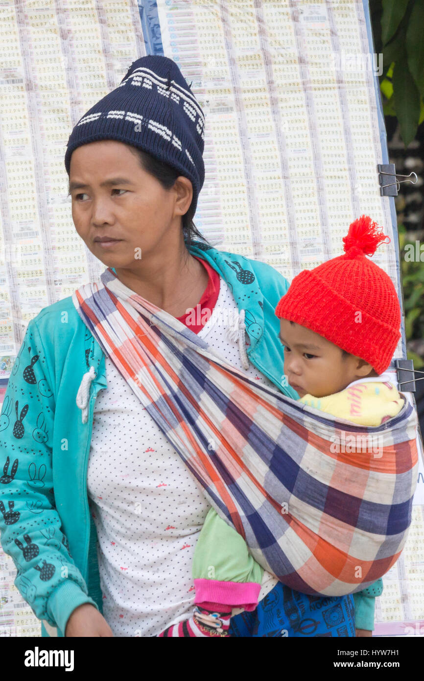 Hill tribe woman with baby in a sling, Chiang Dao, Chiang Mai province, Thailand Stock Photo