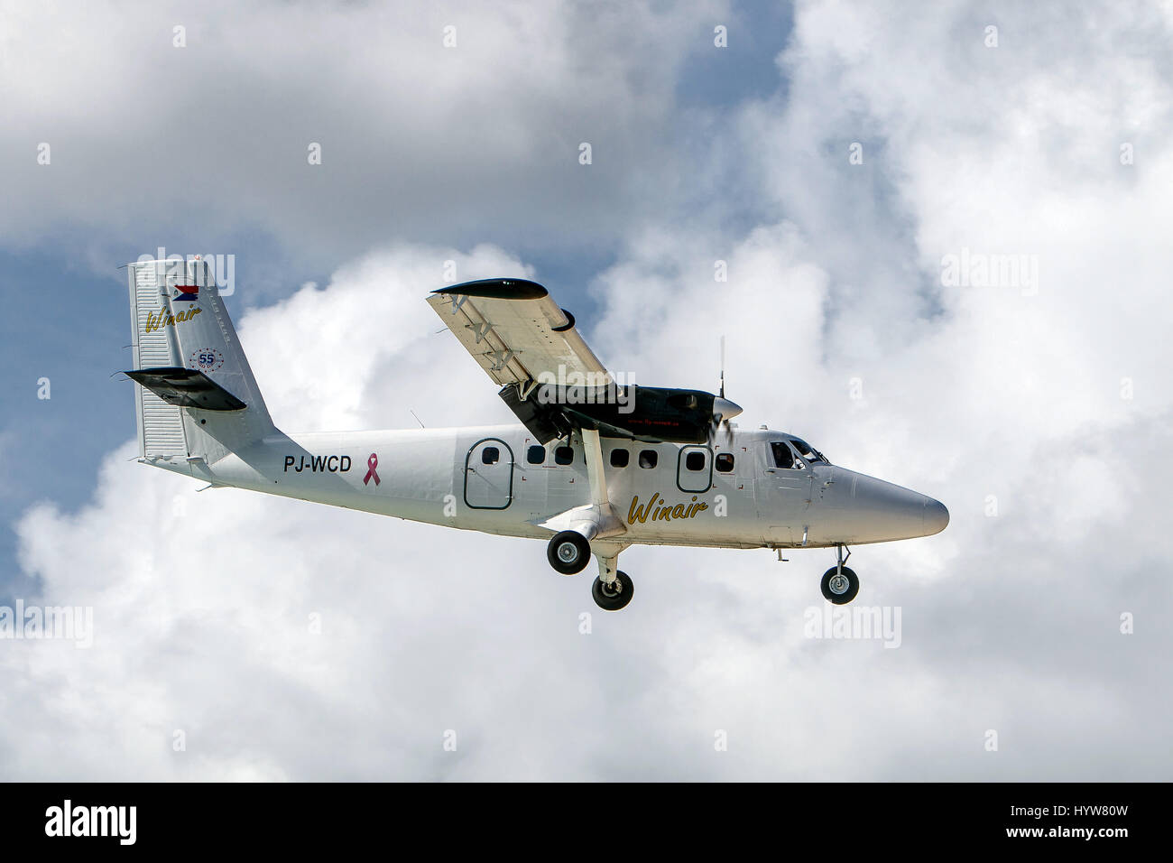 A Winair small plane prepares for landing at Princess Juliana airport. Stock Photo