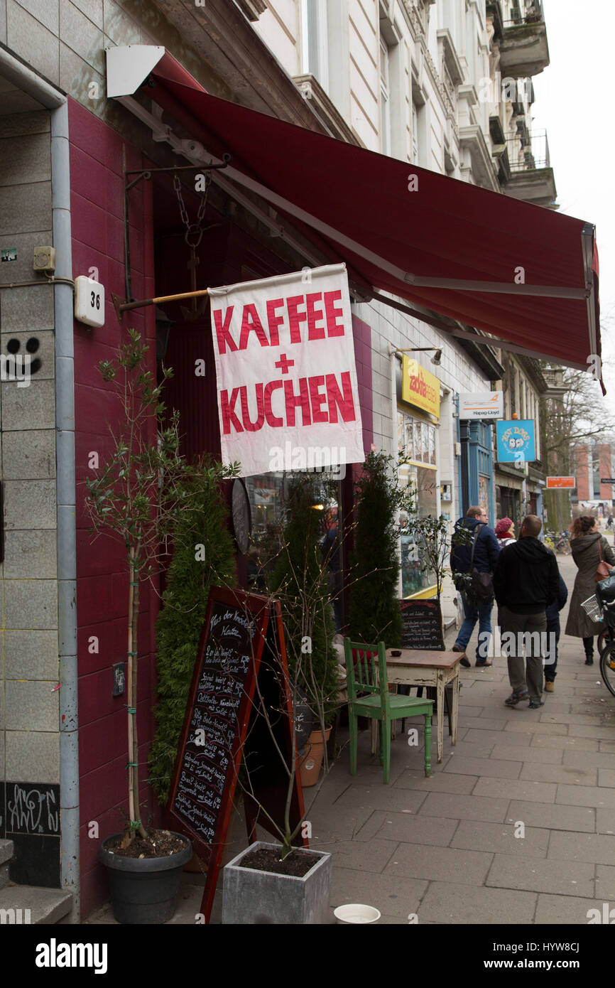Flag advertising 'Kaffee und Kuchen' (coffee and cake) in Hamburg, Germany. The cafe is in the Schanzenviertel. Stock Photo