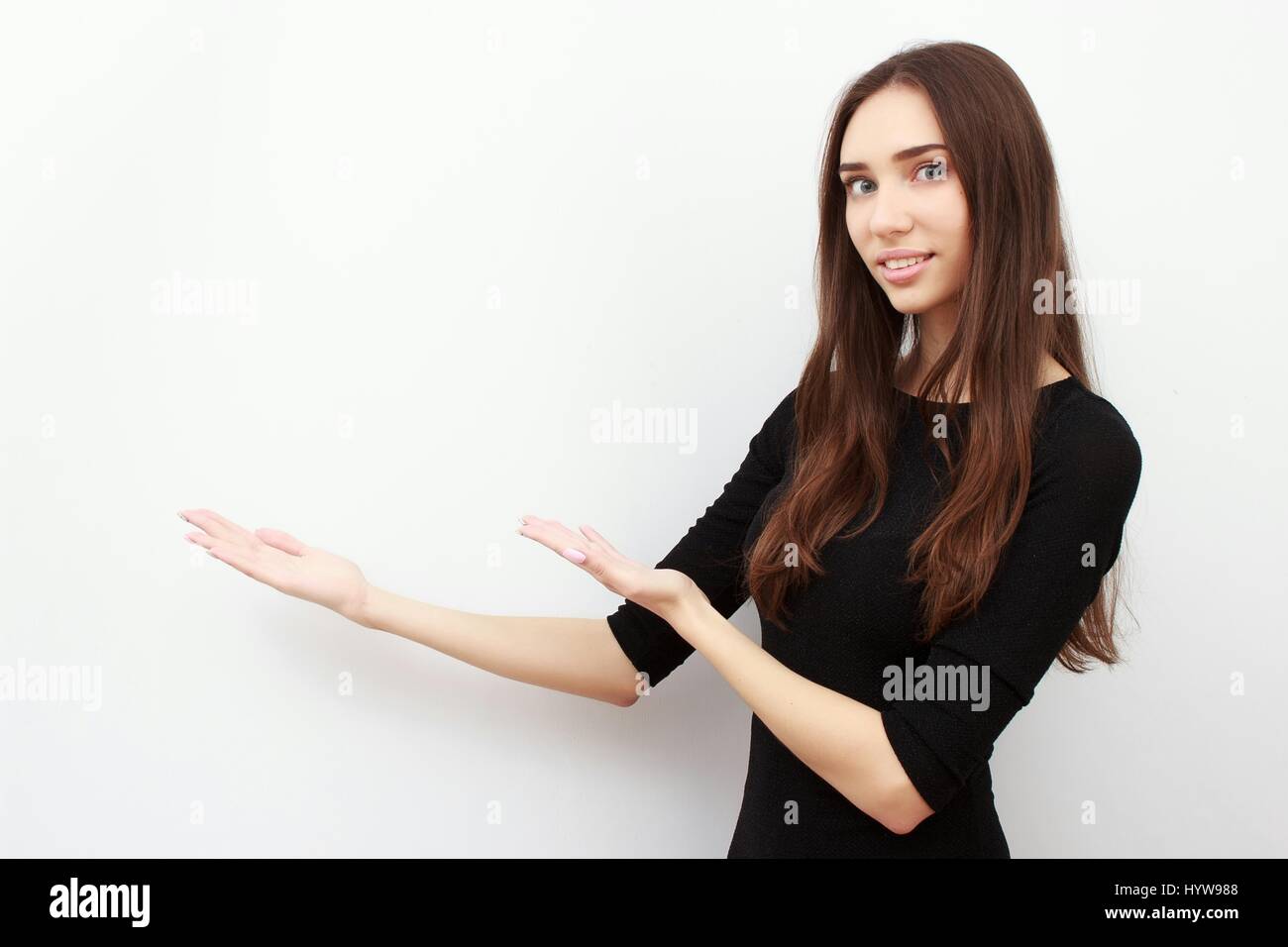 excited young woman presenting copy space on her palm Stock Photo - Alamy
