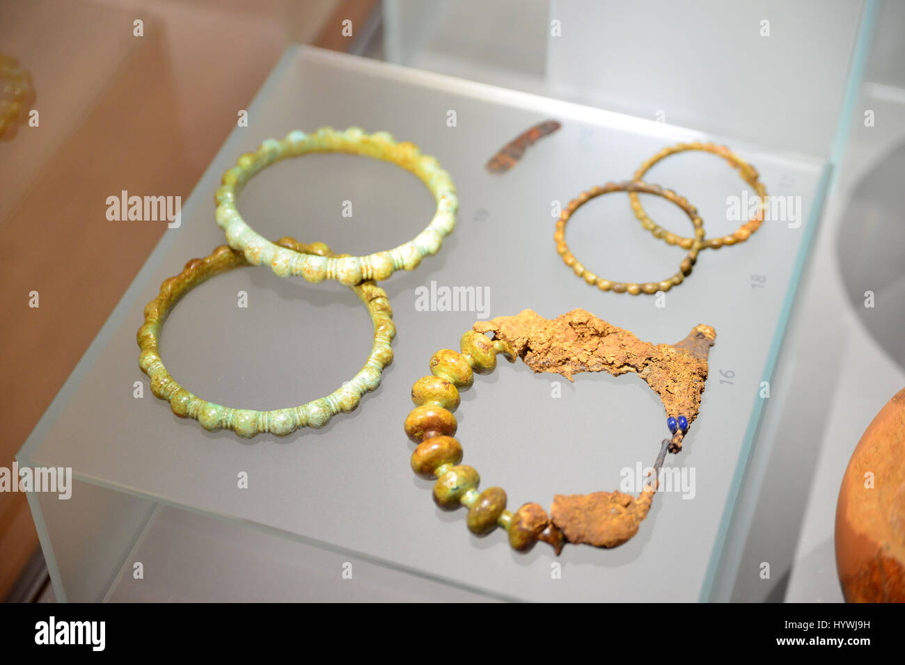 (170426) -- NOVO MESTO (SLOVENIA), April 26, 2017 (Xinhua) -- Bronze fibula, bracelets and anklets from early iron age found in Slovenia are displayed at the exhibition Amber-the Baltic jewels in Novo mesto, Slovenia, on April 26, 2017. The archaeological exhibition Amber-the Baltic jewels in Novo mesto is held here from April 20 to Sept. 30, displaying a selection of archaeological amber materials, which have been preserved by various Slovenian institutions in charge of protecting Slovenian cultural heritage. The exhibits date from the Bronze Age to antiquity. (Xinhua/Matic Stojs) Stock Photo