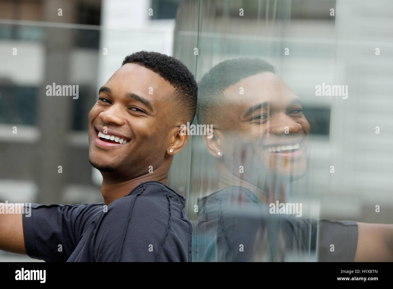 Close up portrait of a handsome young black man smiling Stock Photo - Alamy