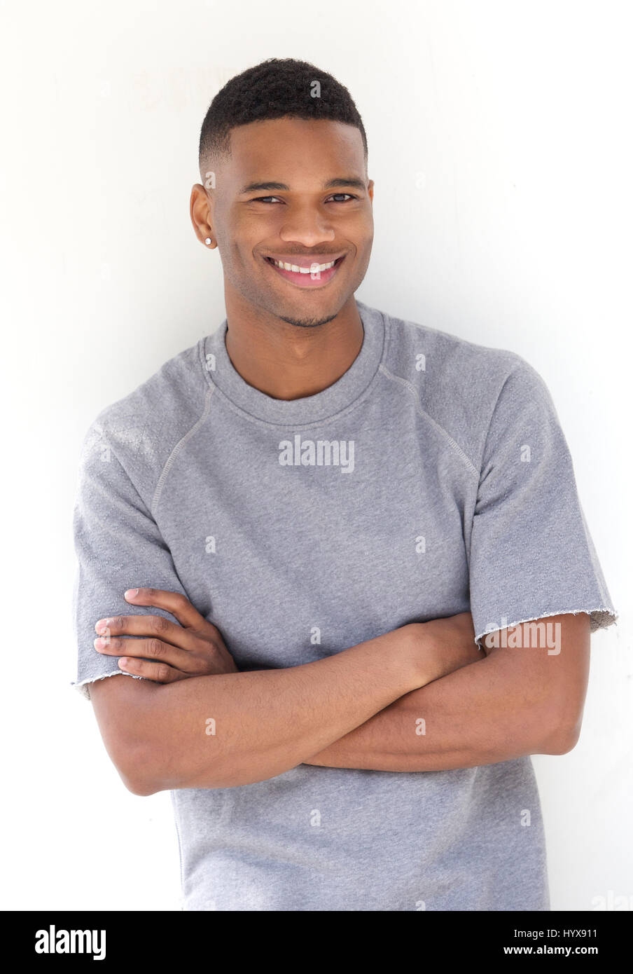 Portrait Of A Cool Young Black Man Smiling With Arms Crossed On