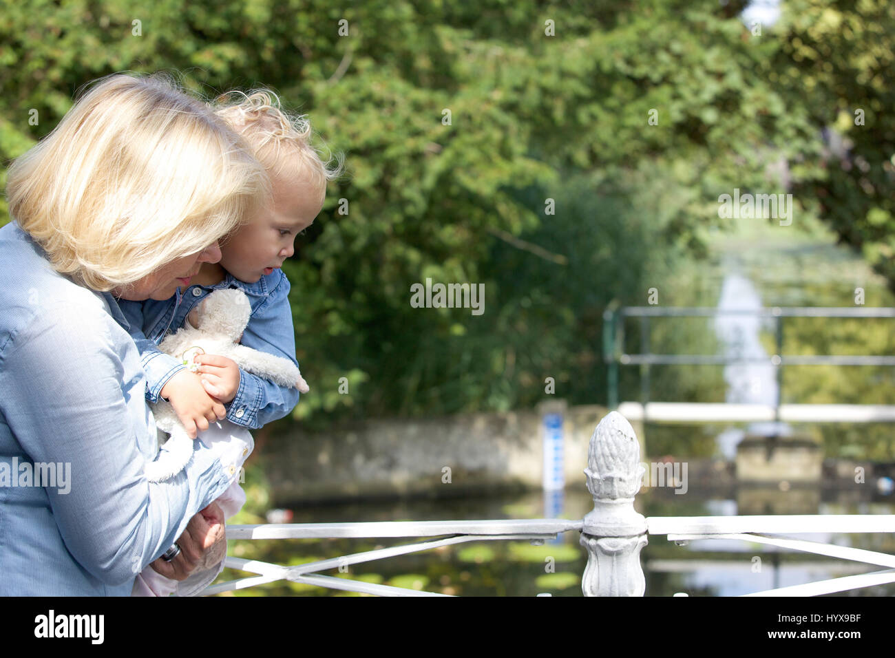 Close up portrait of a grandmother holding baby girl outdoors Stock Photo