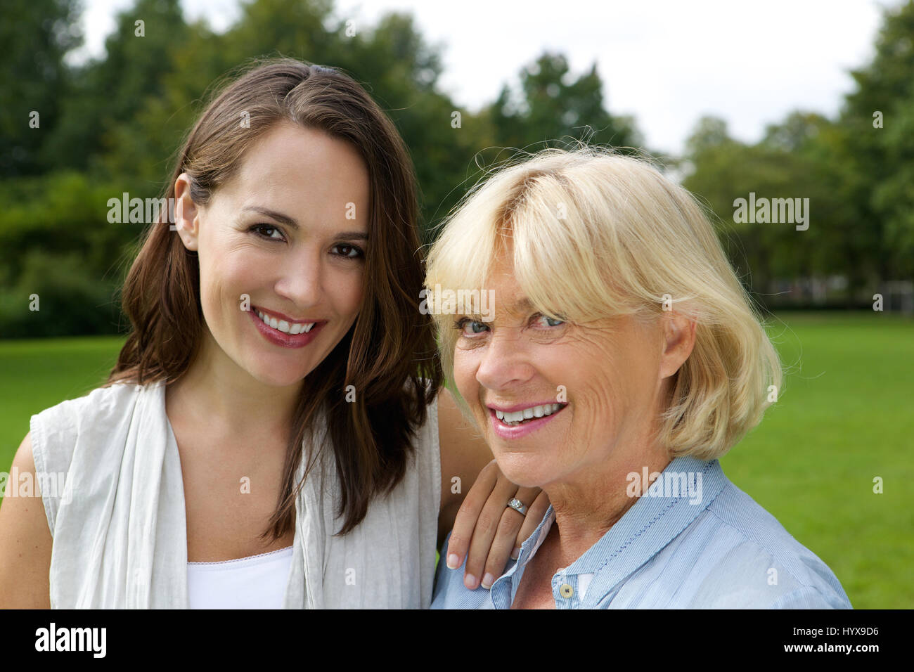 Close up portrait of a mother and older daughter smiling together Stock Photo
