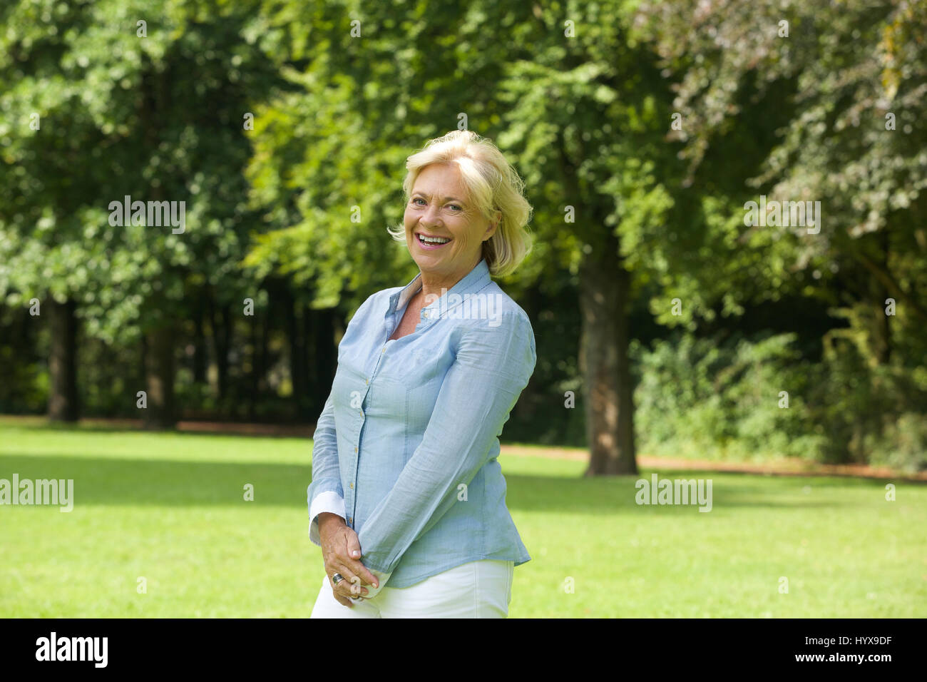 Portrait of a happy older woman smiling outdoors Stock Photo