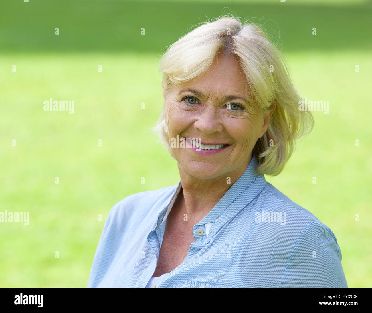 Close up portrait of an older woman smiling outside Stock Photo