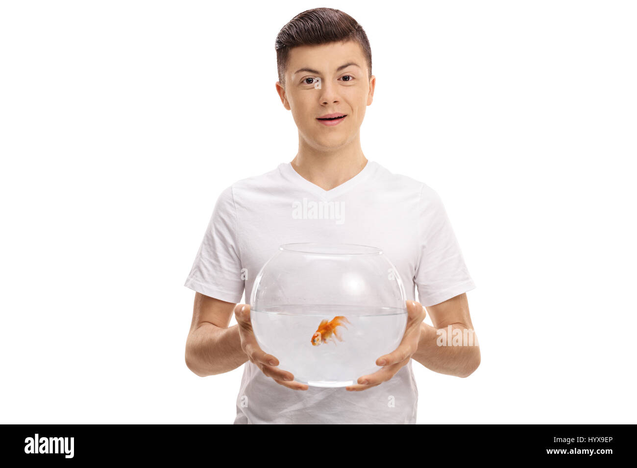 Teenager holding a bowl with a goldfish inside isolated on white background Stock Photo