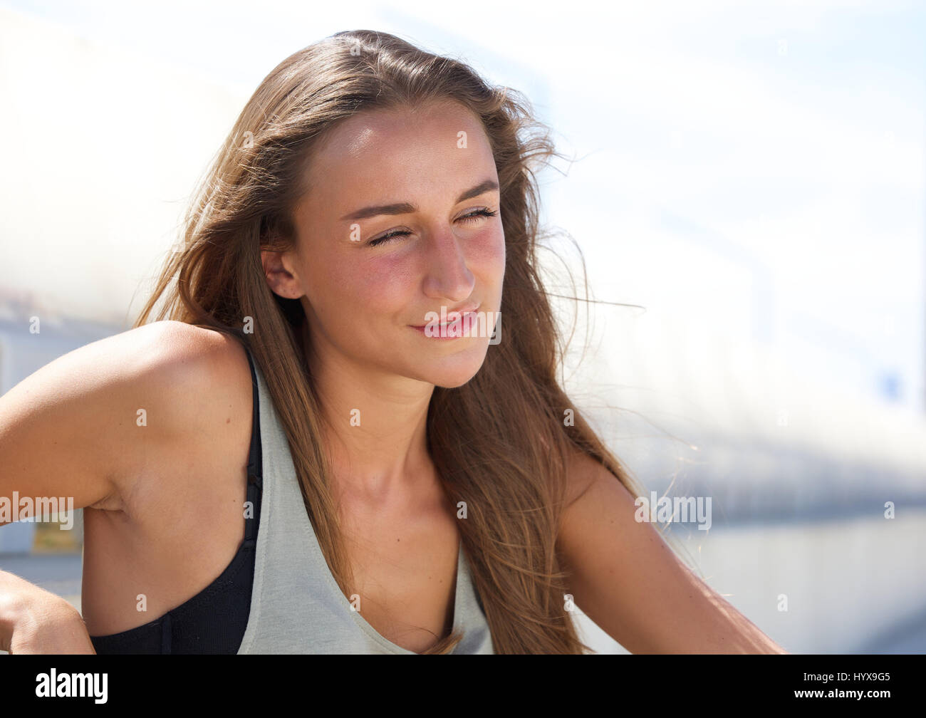 Close up portrait of a cute young woman relaxing outside Stock Photo