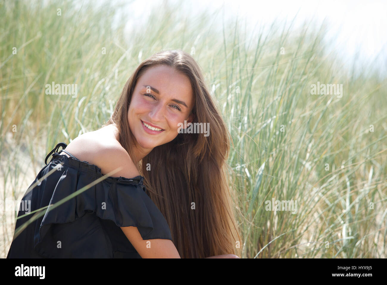 Close up portrait of a young woman smiling outdoors Stock Photo