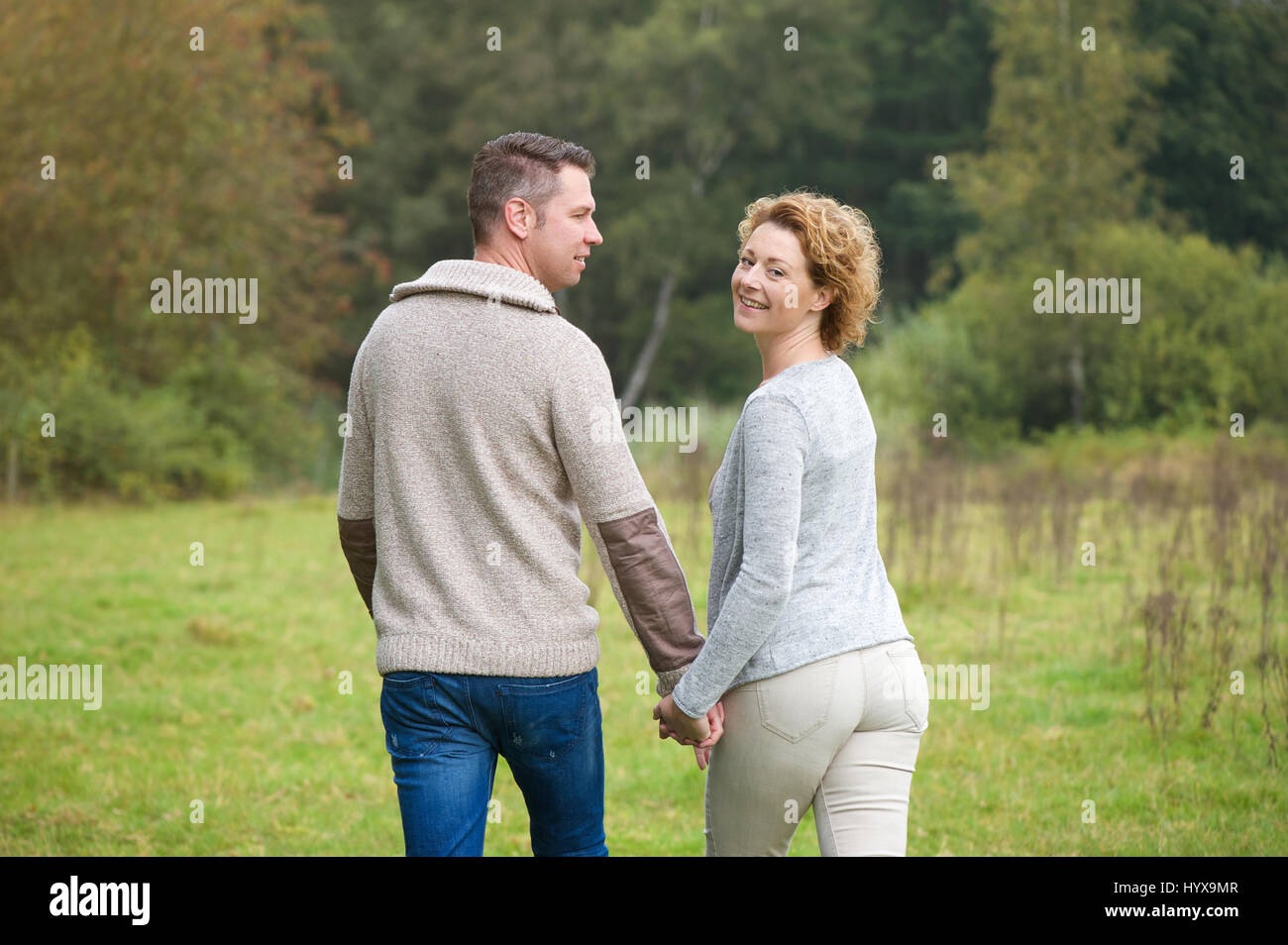 Portrait of a happy couple walking in the countryside Stock Photo