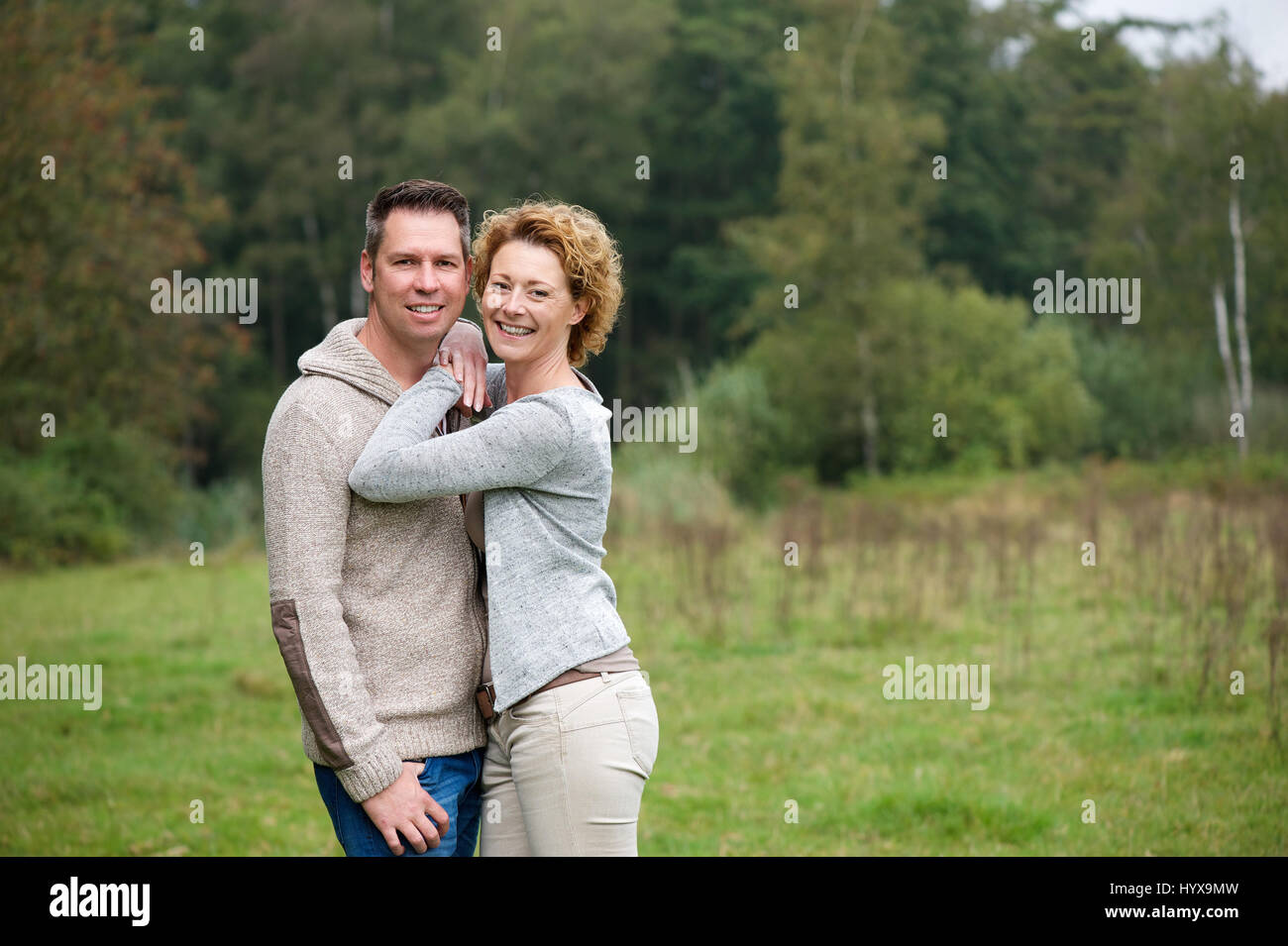 Portrait of a happy couple smiling and hugging outdoors Stock Photo - Alamy