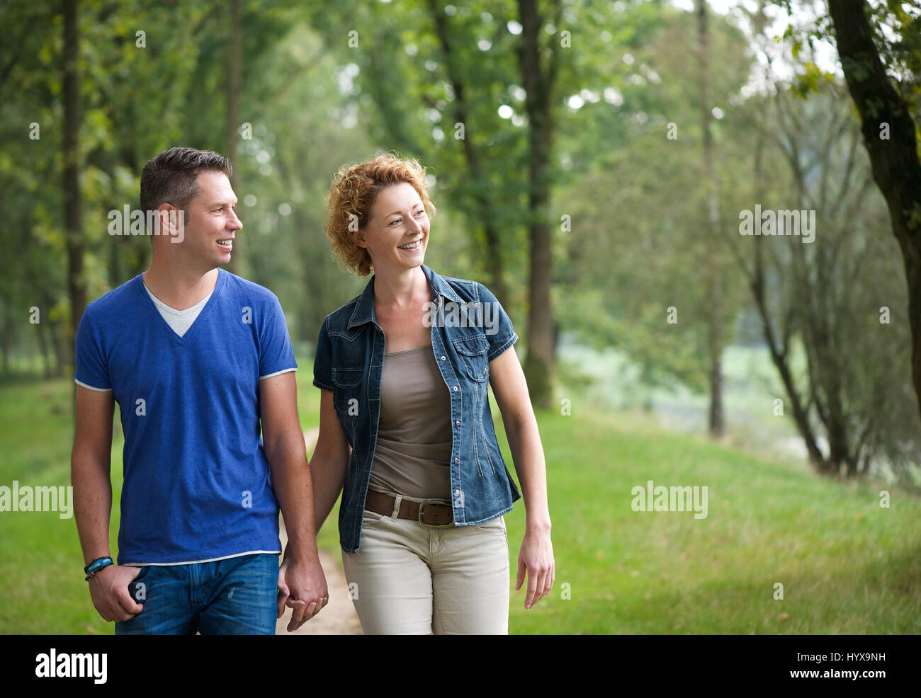 Portrait of a happy couple walking together outdoors Stock Photo