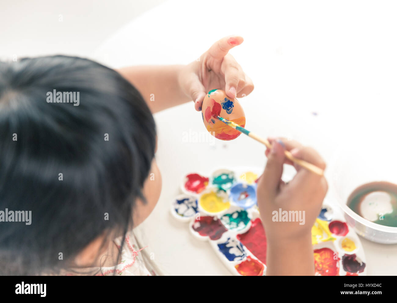 Asian child painting on Easter egg Stock Photo - Alamy