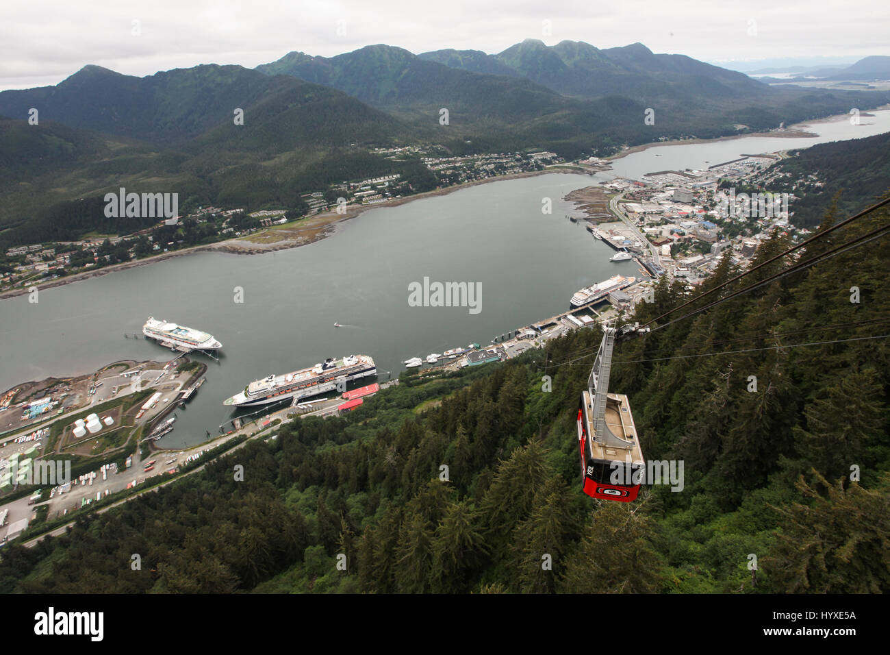 A car from Mount Roberts Tramway travels passengers above Juneau's landscape. Stock Photo
