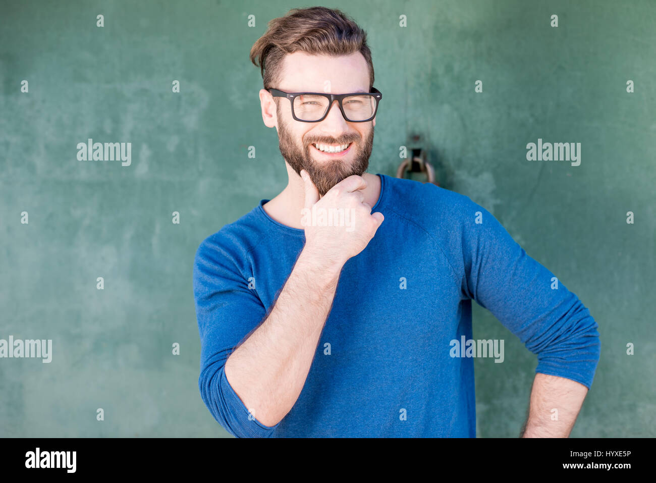 Portrait of a man on the green background Stock Photo - Alamy