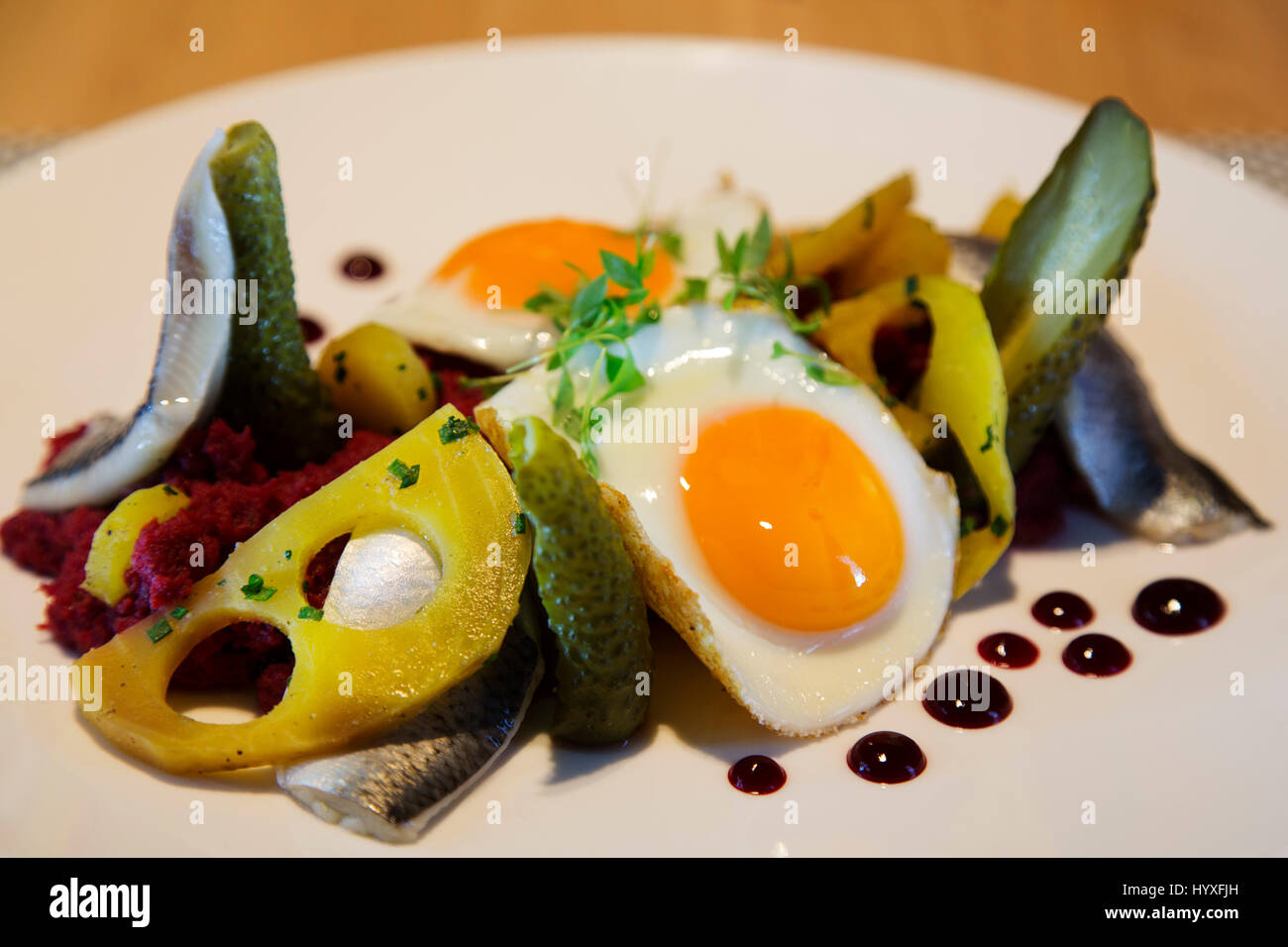 Labskaus, a traditional stew, served in Hamburg, Germany. The dish, features fish, potato, beetroot and meat topped with fried egg. Stock Photo