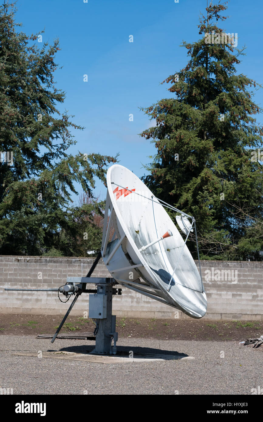 EUGENE, OR - MARCH 31, 2017: Communcations dish for cable television at a media facility that has been abandoned. Stock Photo