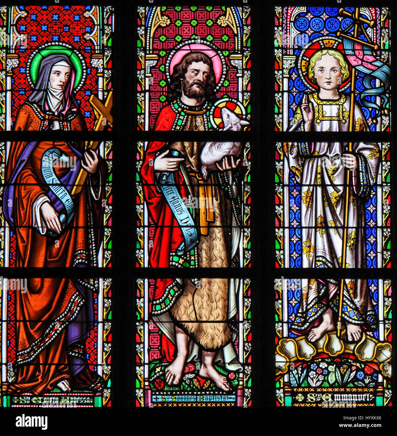 Stained Glass in the Church of Our Blessed Lady of the Sablon in Brussels, Belgium, depicting Saints Colette, John the Baptist and Emmanuel Stock Photo