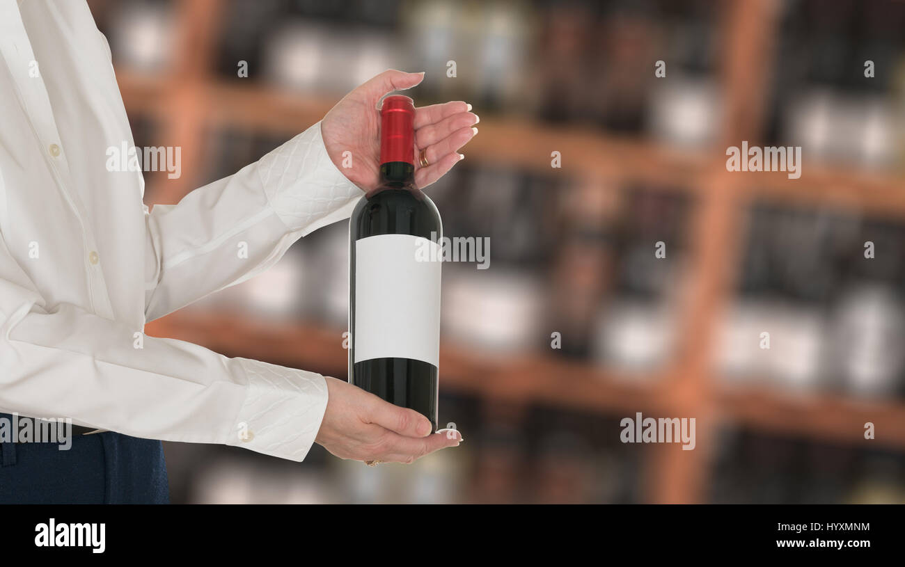 Sommelier offering bottle of red wine to customer Stock Photo