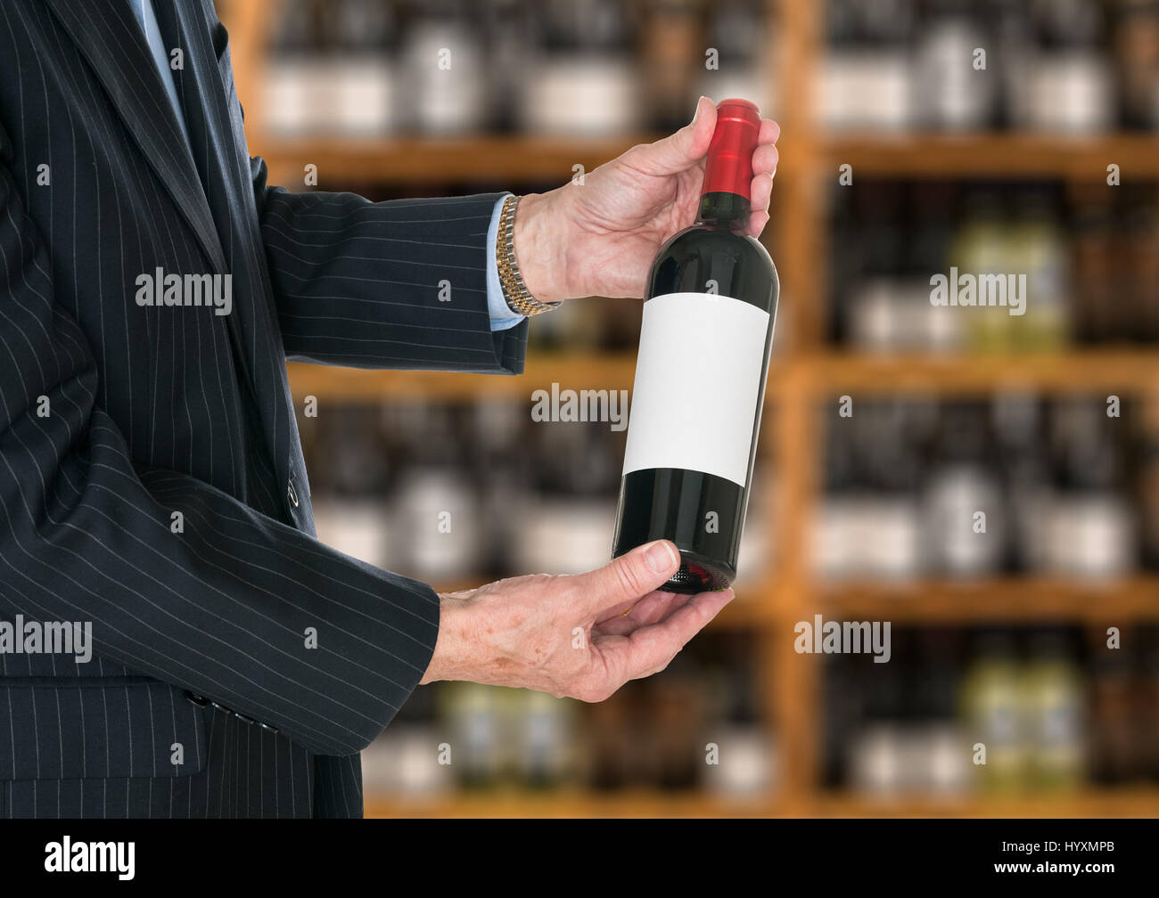 Sommelier offering bottle of red wine to customer Stock Photo