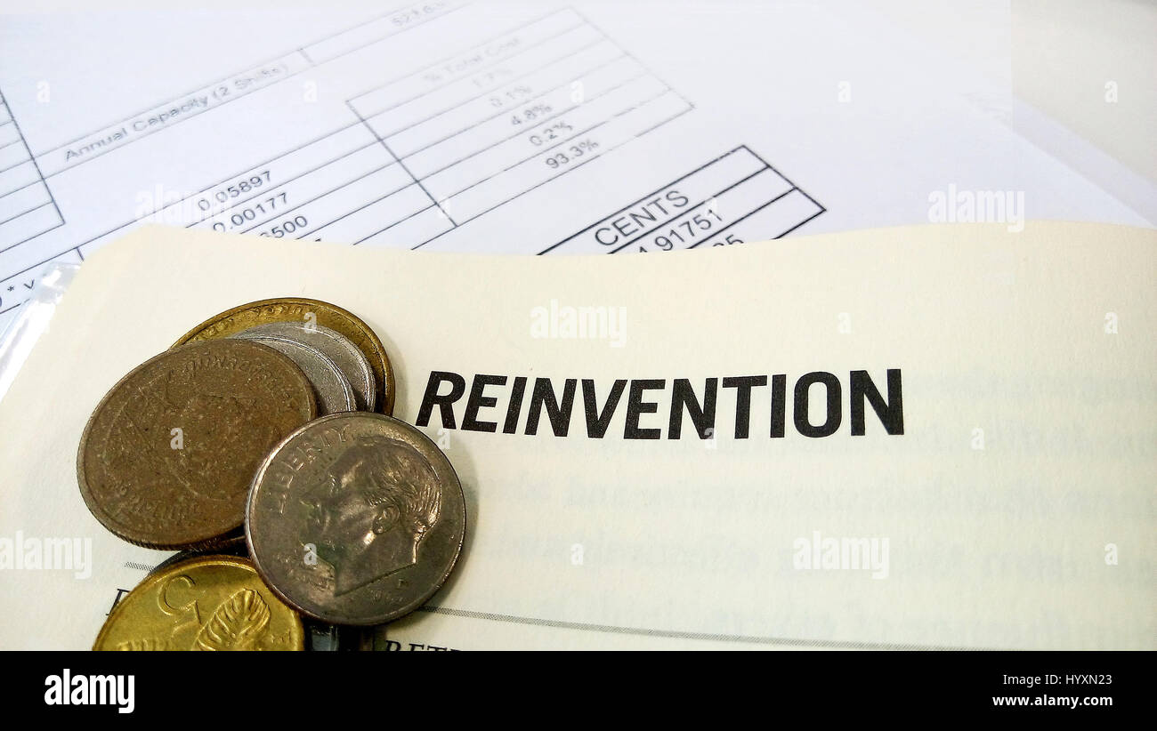 Reinvention word on the book with balance sheet as background Stock Photo