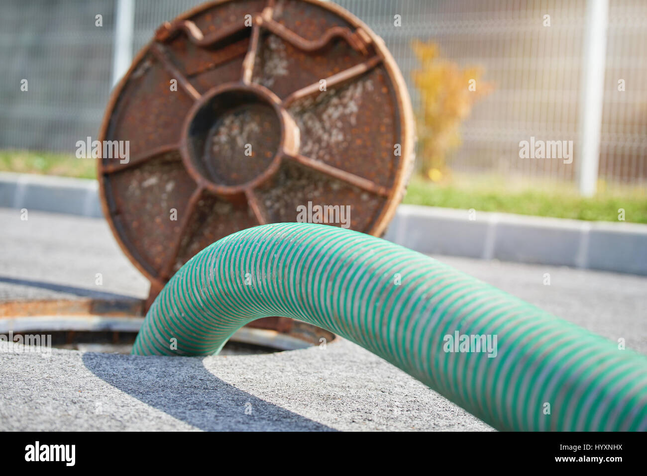 Emptying septic tank, cleaning the sewers Septic cleaning and sewage removal. Emptying household septic tank. Cleaning sludge from septic system. Stock Photo