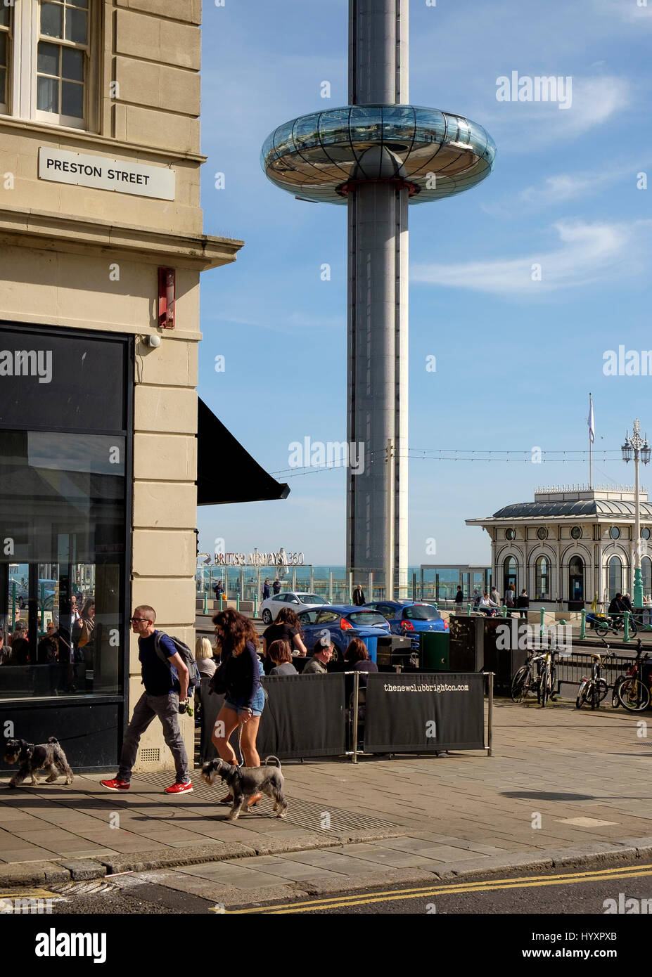 30 March 2017: The pod of the British Airways i360 observation tower ascends from promenade level to 450 feet  above people at seafront cafes in Brigh Stock Photo