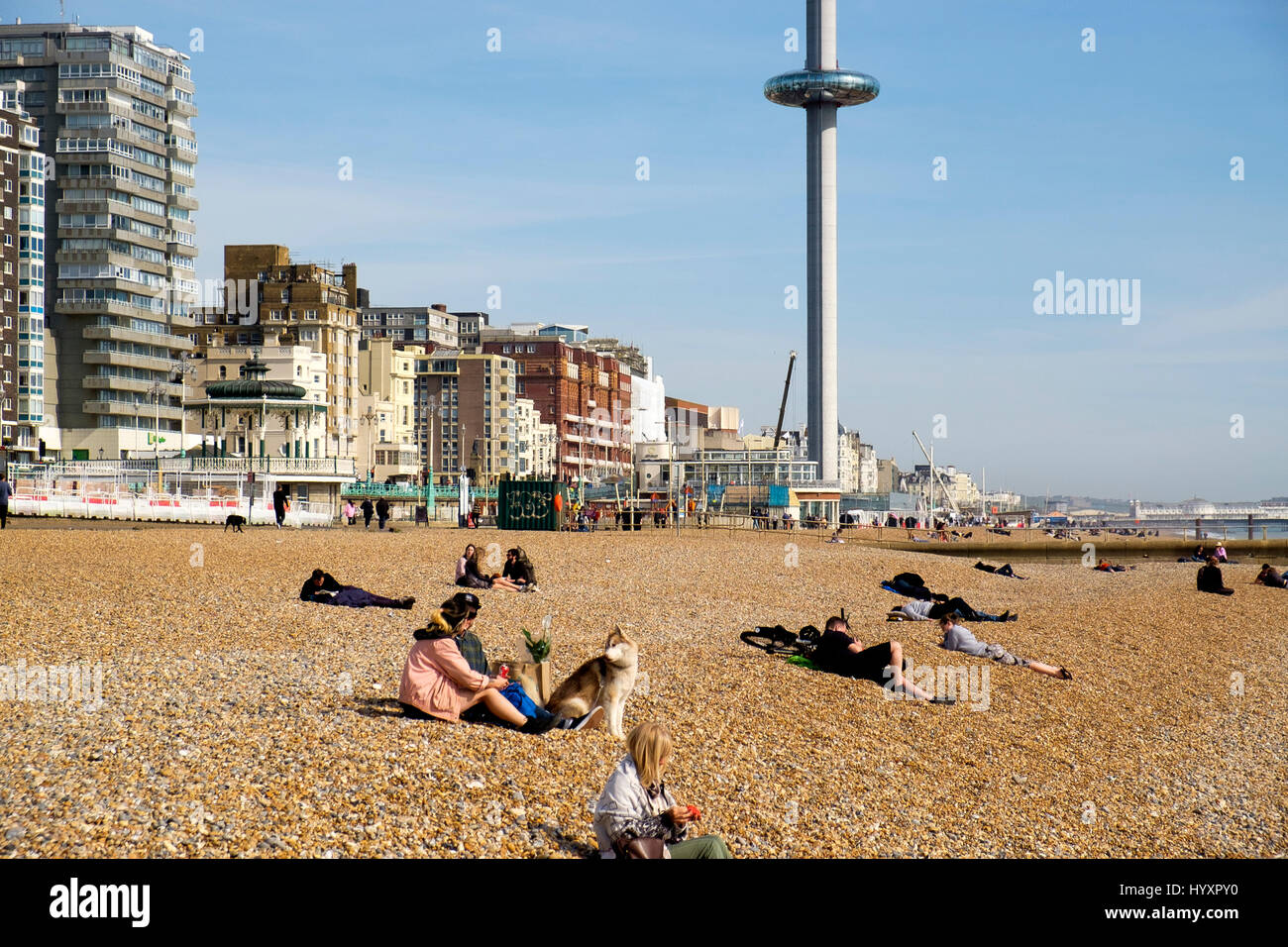 30 March 2017: The pod of the British Airways i360 observation tower ascends from promenade level to 450 feet  above people at seafront cafes, on the  Stock Photo