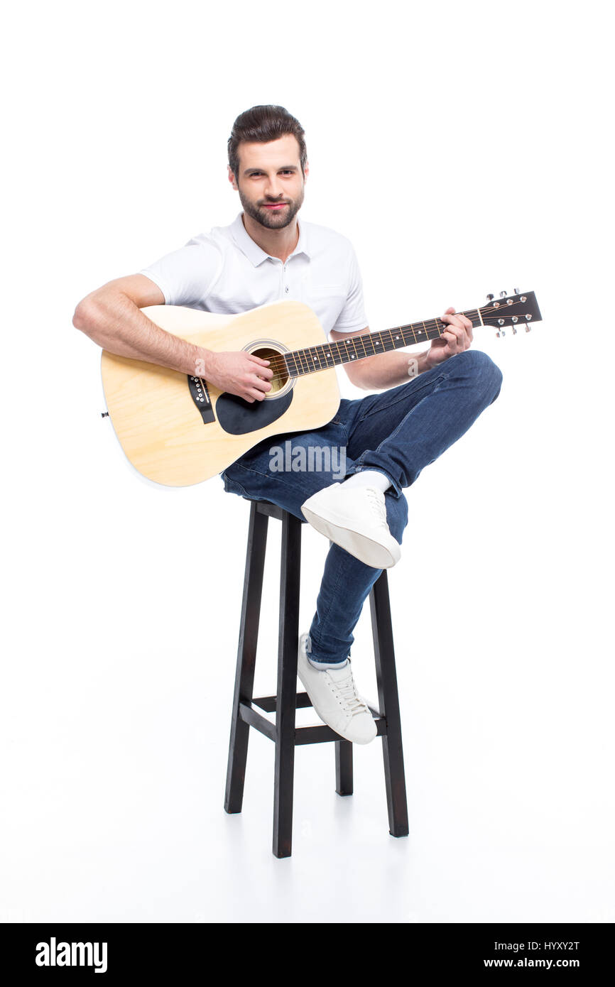 Handsome young man with guitar sitting on bar stool isolated on white Stock  Photo - Alamy