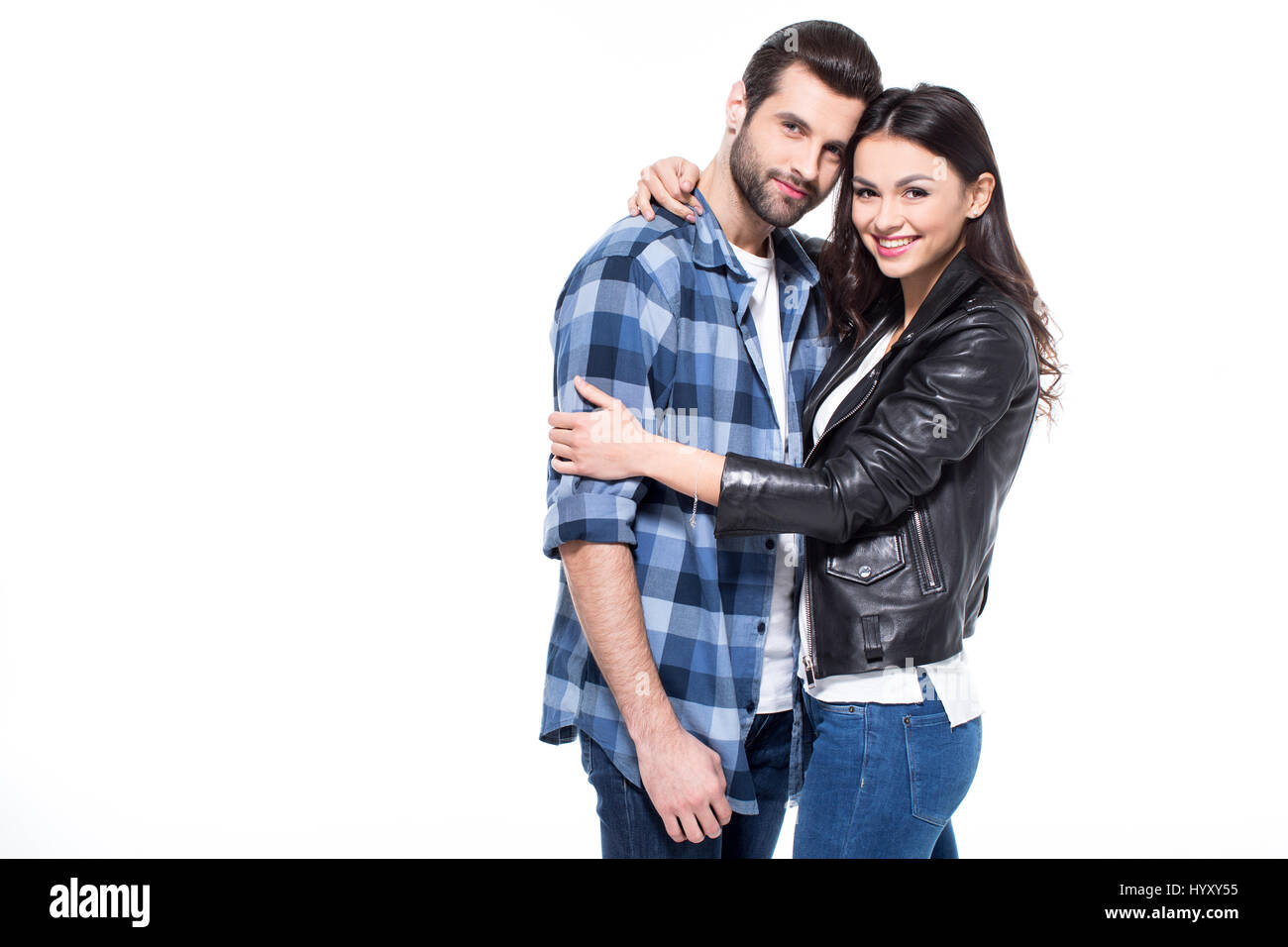 Beautiful young couple hugging and smiling at camera on white Stock ...