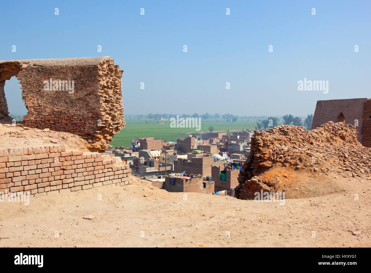 restoration work at bhatner fort historical site in hanumangarh rajasthan india with a view of the outskirts of the city and countryside under a blue  Stock Photo