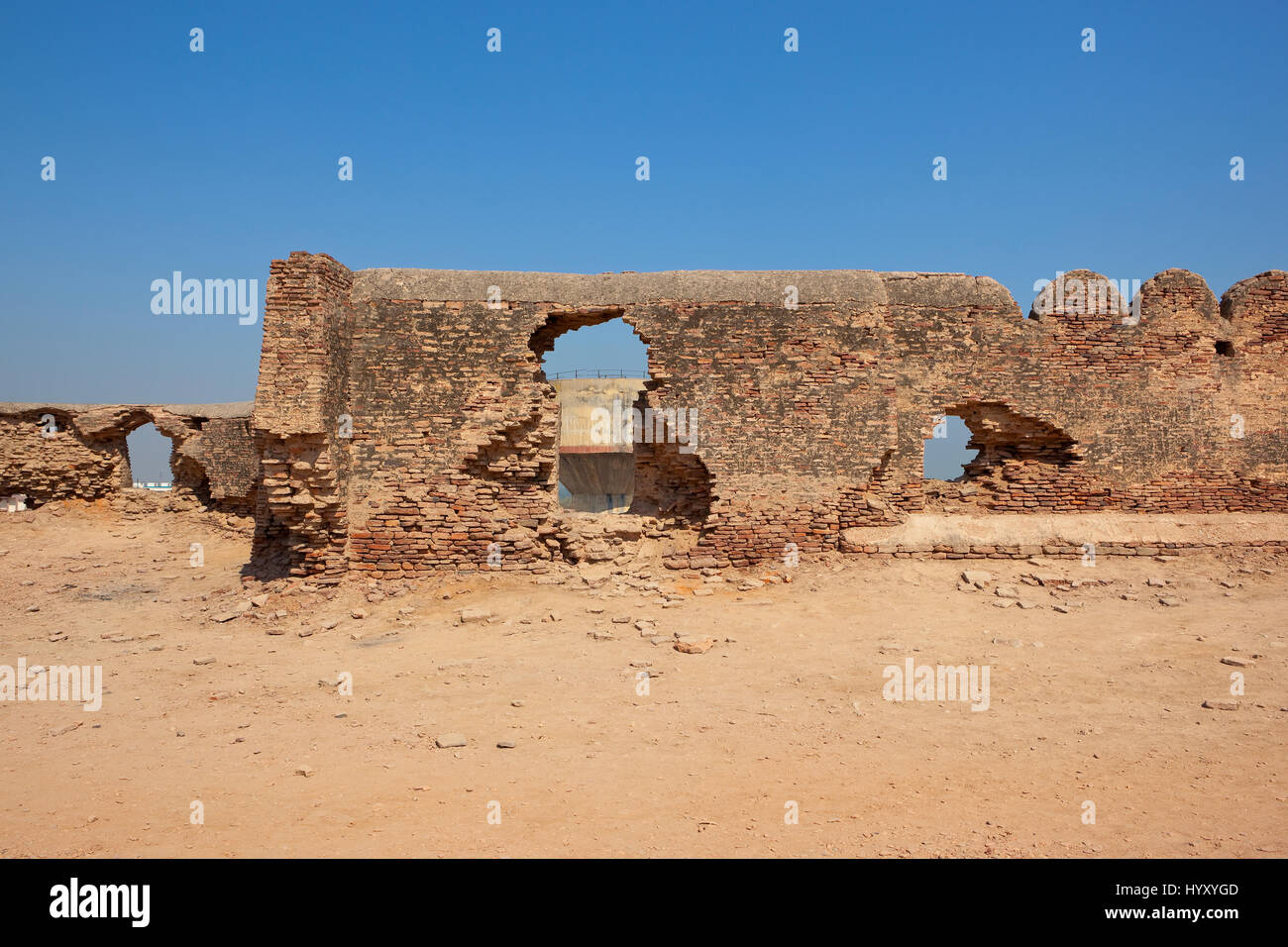 restoration work at bhatner fort historical site in hanumangarh rajasthan india with a water tower under a clear blue sky Stock Photo