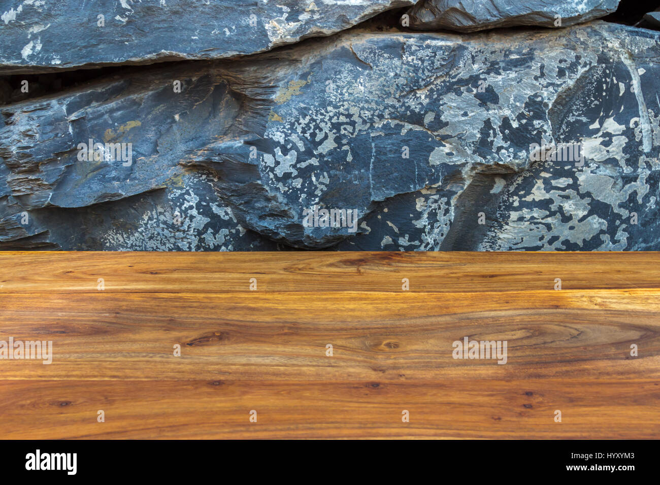 Treated reddish brown wood timber with exotic natural stonewall as