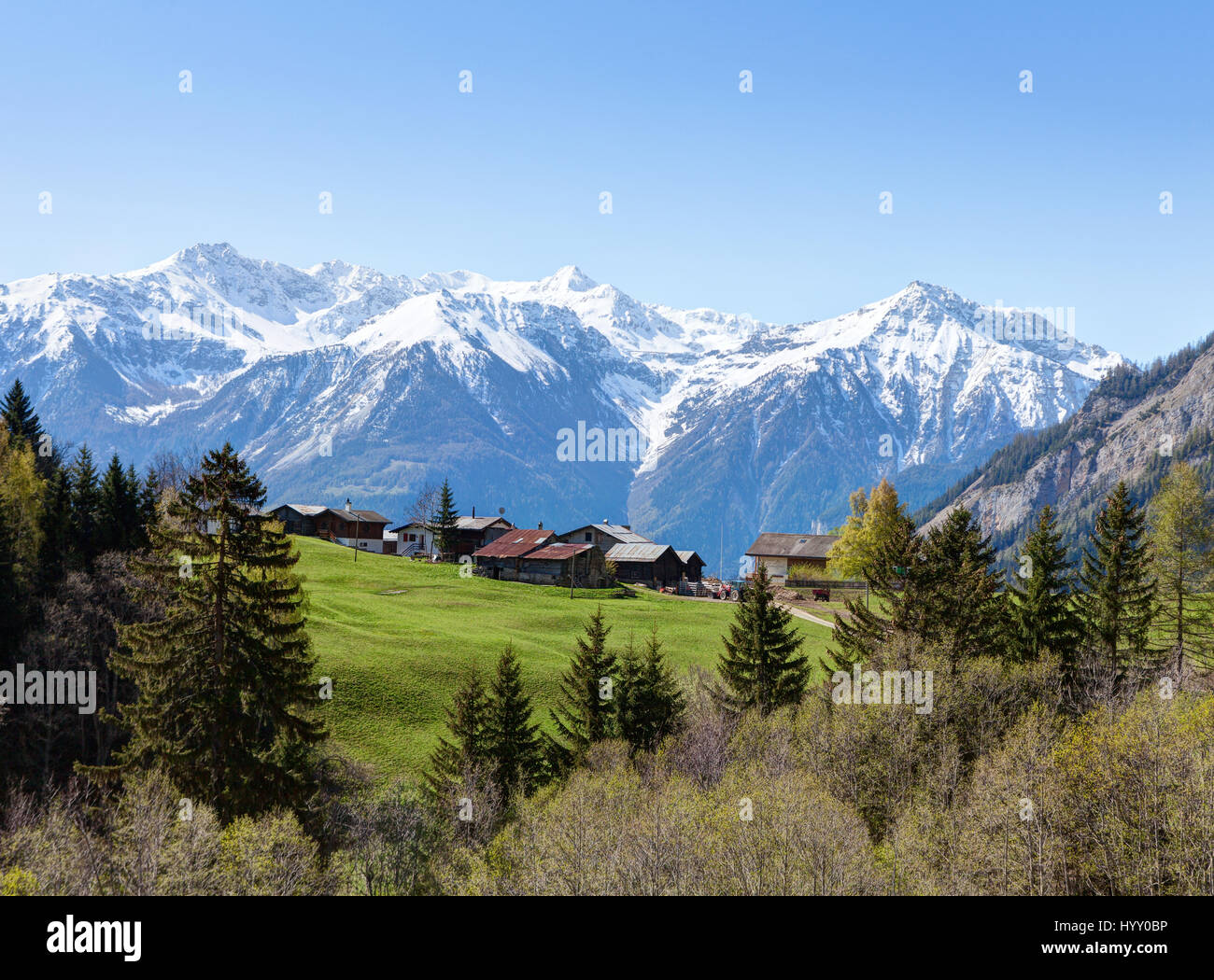 Small farm at   early spring  morning  in Swiss alps (near Leukerbad).  Bodmen, Valais, Switzerland. Stock Photo