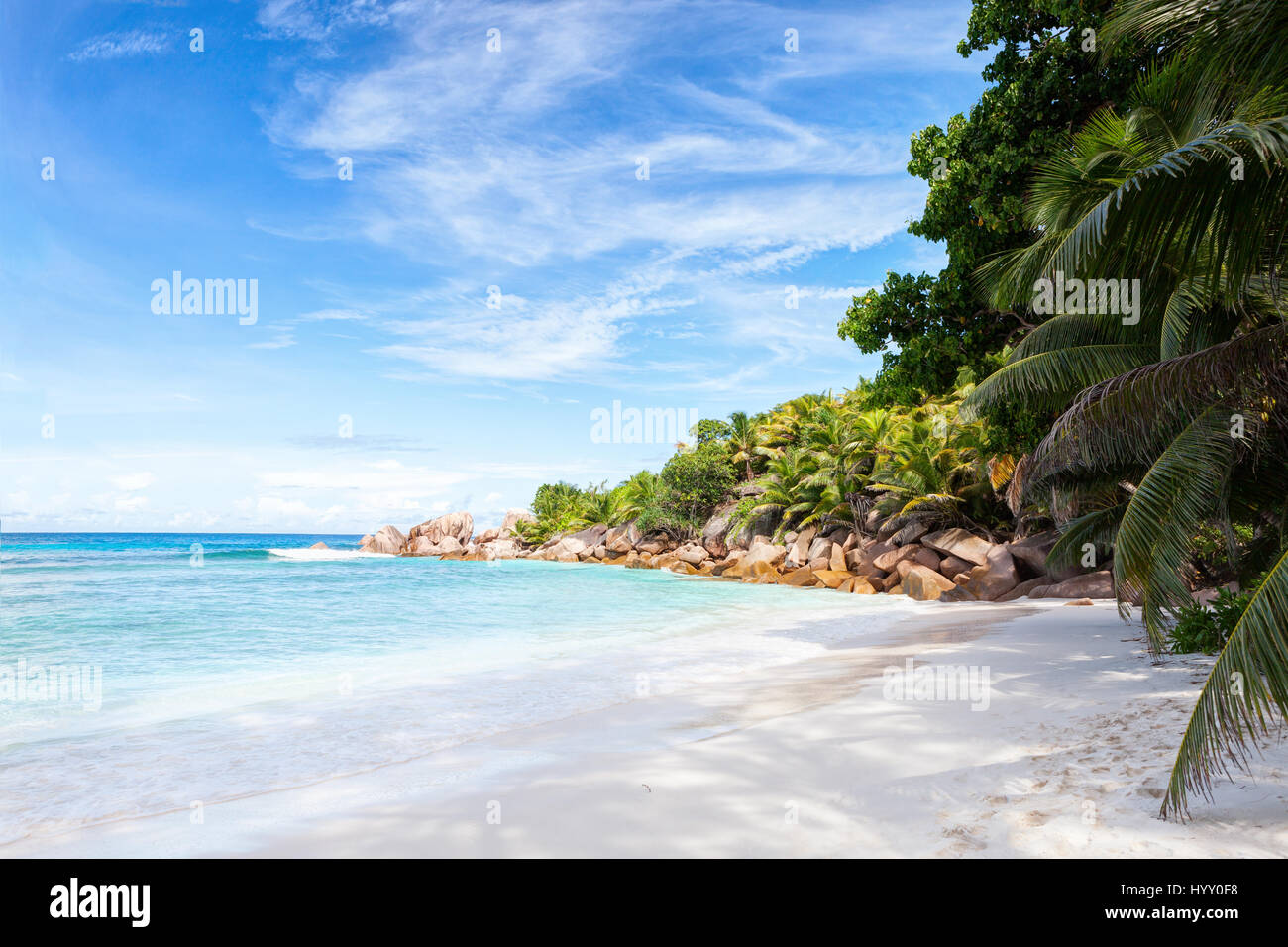 Beautiful tropical  sand beach with granite rocks and coconut palm trees.  La Digue, Seychelles. Stock Photo