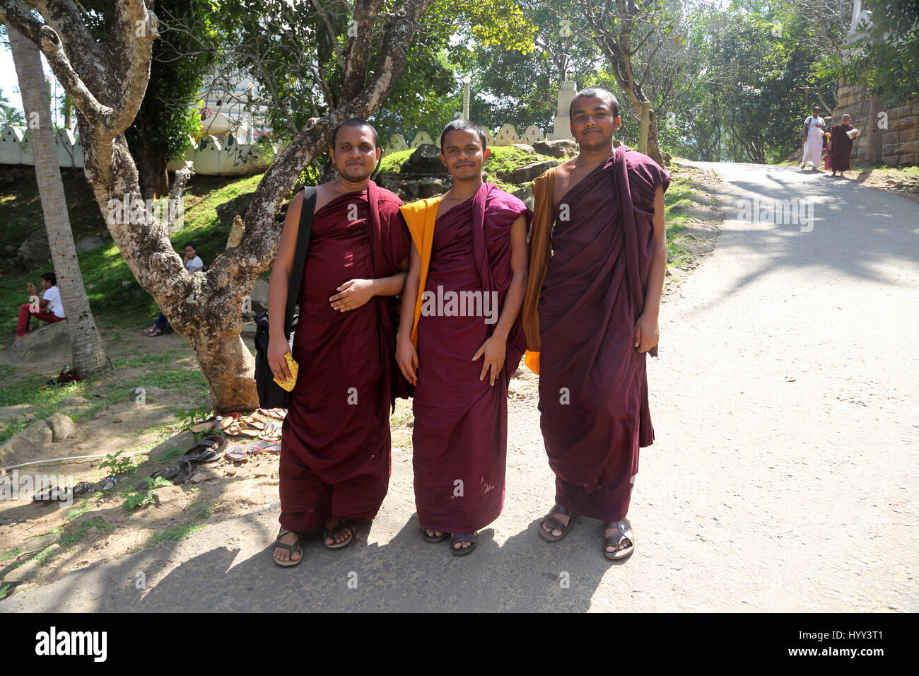 Aluviharaya Rock Cave Temple Sri Lanka Matale District Kandy-Dambulla Highway Three Buddhist Monks In Robe Smiling Stock Photo
