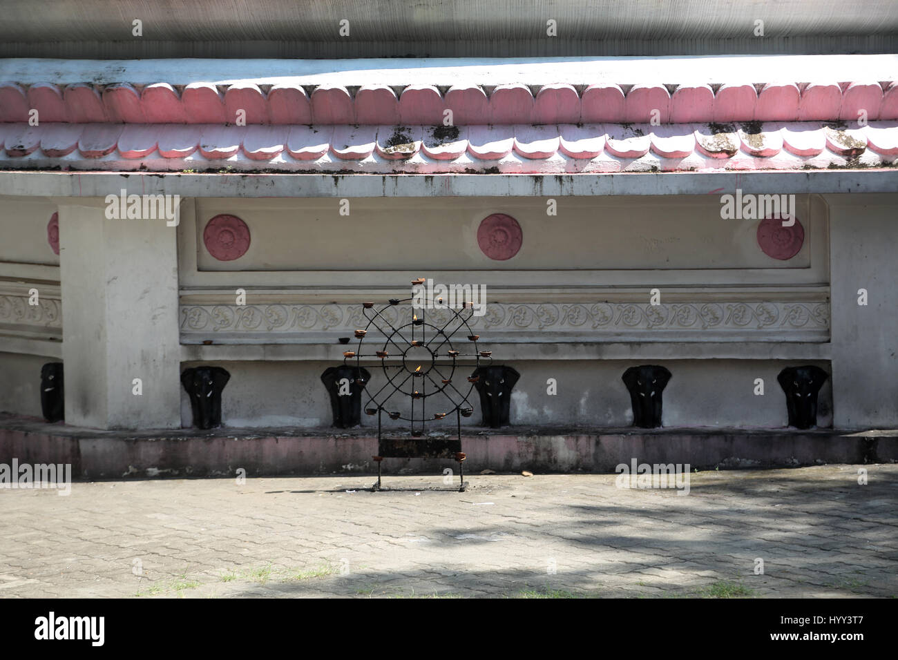 Aluviharaya Rock Cave Temple Sri Lanka Matale District Kandy-Dambulla Highway Butter Lamps In Dharma Wheel Frame In Front Of Dagoba Stock Photo