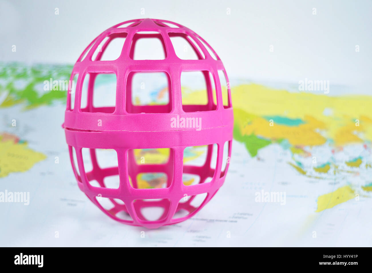 Pink Hollow Globe over a world map background Stock Photo - Alamy