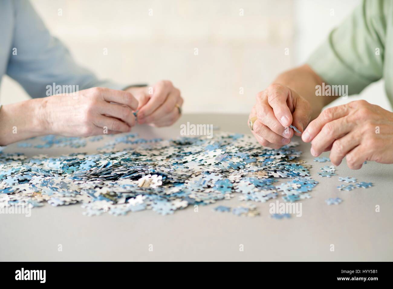 Senior couple doing a jigsaw puzzle. Stock Photo