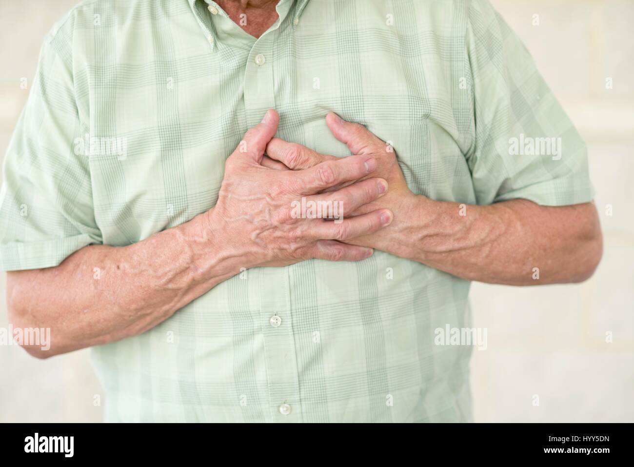 Senior man holding his chest in pain. Stock Photo