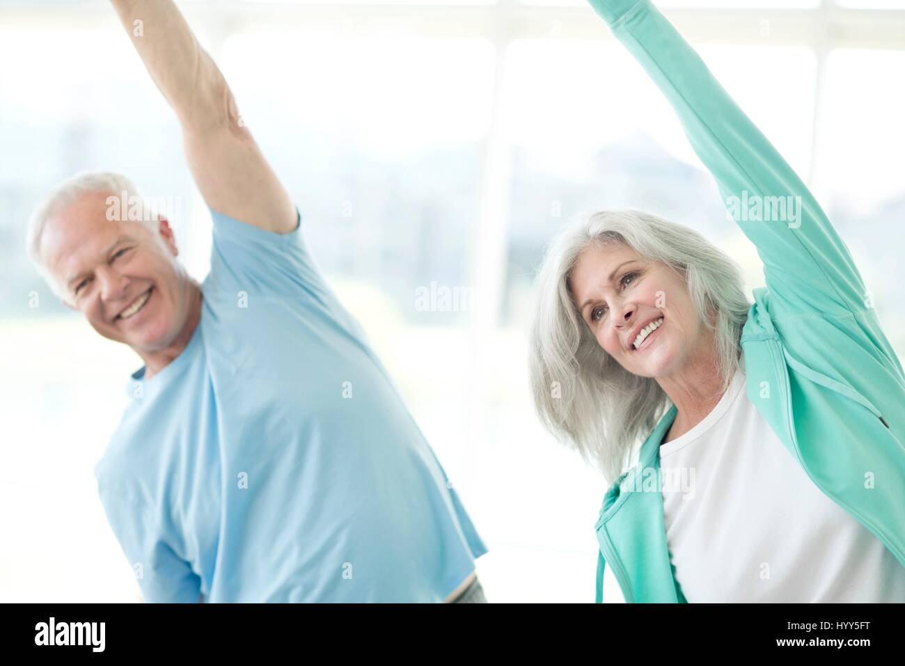 Senior couple stretching arms upwards. Stock Photo